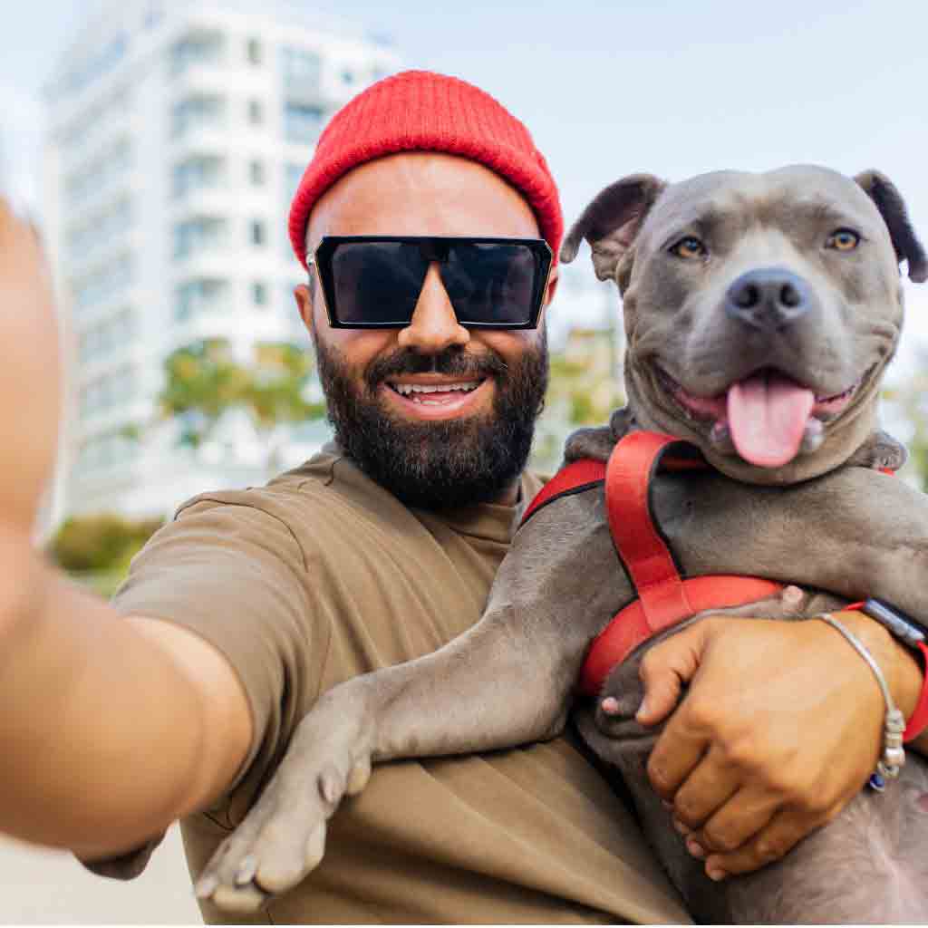 man taking selfie with dog